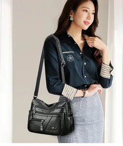 Detail shot of multi-pocket soft leather crossbody bag with adjustable shoulder strap