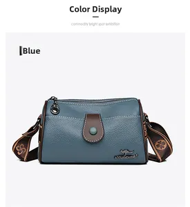 Detail of blue lychee grain leather cylinder bag with kangaroo logo and woven strap