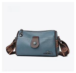 Micro side view of blue lychee grain leather pillow bag with brown logo detailing