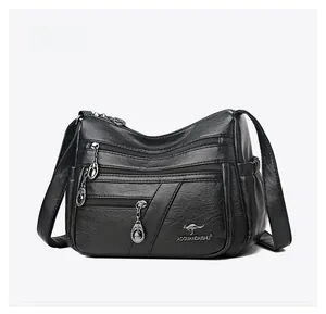 Detailed side view of black pebble leather shoulder bag with multi-pocket zippers
