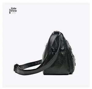 Side view of multi-pocket black leather crossbody bag with silver chain and litchi texture