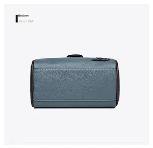 Detailed bottom view of blue-grey leather handbag with reinforced double stitching