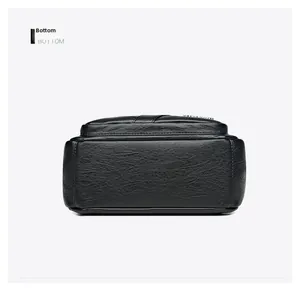 Detail view of the textured black leather bottom and fine stitching of the shoulder bag