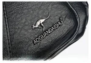 Close-up of black lychee grain leather handbag featuring silver kangaroo metal logo