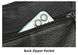 Detail of the back zipper pocket on a black pebble leather handbag with phone