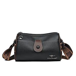 Minimalist black lychee leather crossbody bag with brown straps and kangaroo metal logo