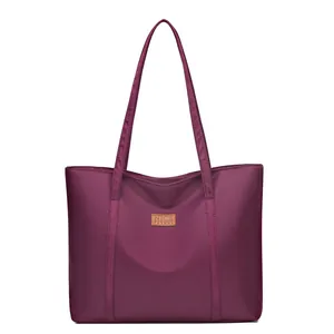 Deep purple nylon tote bag with brown leather patch logo and long shoulder straps