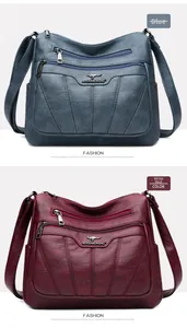 Detalle de bolsos bandolera bordados en cuero elegante en colores azul y rojo vino
