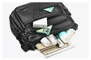 Detail showing the large capacity of the black multi-layer leather crossbody bag