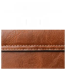 Detailed close-up of caramel brown lychee texture leather with white contrast stitching