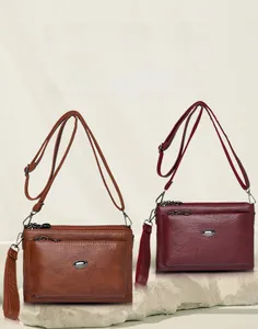 Detail of soft PU leather shoulder bags showing metal hardware and zipper compartments
