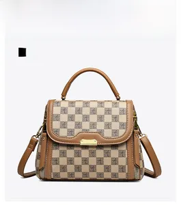 Front view of a khaki monogrammed handbag with a metal lock and leather handle