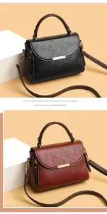 Close-up of litchi grain leather texture and metallic rectangular buckle on handbags