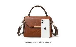 Size comparison between retro brown leather handbag and iPhone 12 for scale display