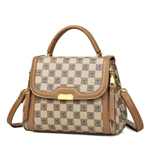 Brown monogram handbag with A-pattern chessboard design and golden metallic clasp
