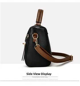 Vue latérale du sac bandoulière en cuir noir avec anses brunes et finitions dorées