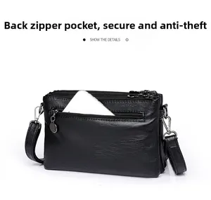 Detalle del bolsillo con cremallera antirrobo en la parte trasera del bolso de cuero negro