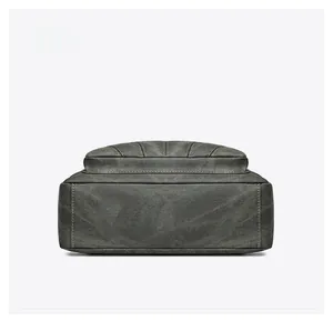 Detailed bottom view showing reinforced stitching and texture of grey canvas shoulder bag