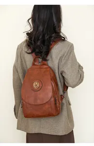 Brauner PU-Lederrucksack Detail an weiblichem Model mit strukturiertem braunem Blazer
