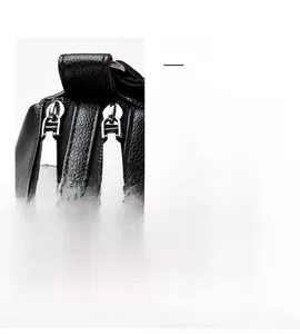 Detail view of the silver metal zipper and kangaroo logo on the black leather bag