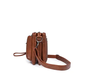 Detail view of brown multi-layer soft leather crossbody bag with four zip compartments