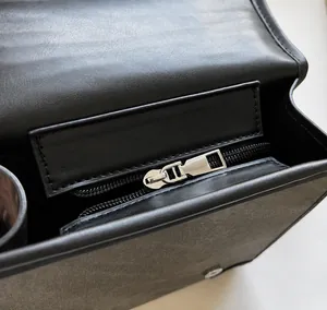 Detail of smooth silver metal zipper and premium leather texture on British style bag