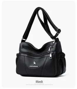 Close-up of black lychee grain leather crossbody bag with multiple zipper compartments