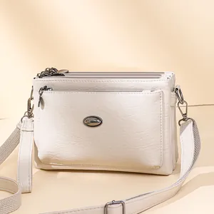 Chic cream white multi-compartment shoulder bag in soft leather with adjustable strap