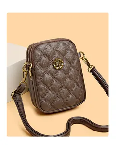 Détail du sac bandoulière en cuir matelassé marron foncé avec double zip et métal doré