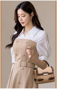 Detail of elegant two-tone faux leather crossbody bag with premium gold hardware