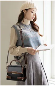 Retro black and brown leather handbag styled with vintage British fashion outfit