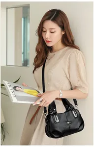 Close-up of elegant black leather handbag featuring silver hardware and a kangaroo logo
