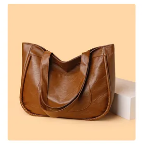 Detailed view of caramel brown tote bag with retro pleated texture and large front pocket