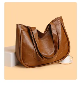 Detailed close-up of dark brown leather tote bag showing soft texture and spacious design