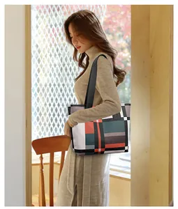 Detail of multi-color geometric patchwork tote bag shown on model for daily commuting