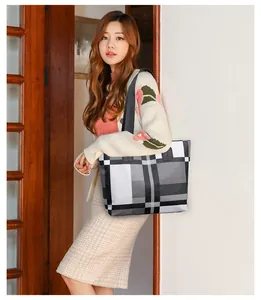 Chic checkered tote bag worn as a shoulder bag on a female model with stylish plaid pattern