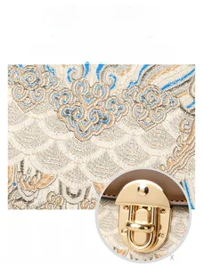 Detail of vintage jacquard fabric and gold buckle on a retro Chinese style crossbody bag