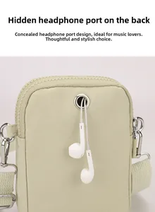 Detail of light green nylon phone bag featuring a metal headphone jack and silver zipper