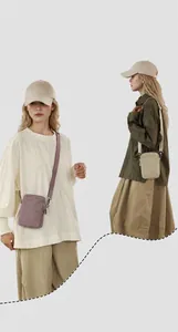 Side-by-side view of minimalist nylon mini crossbody bags in purple and beige tones