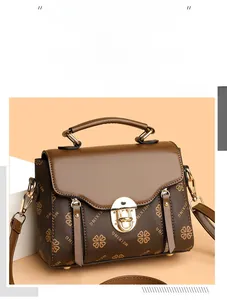 Detail of retro leather crossbody bag with MEIXING logo and metallic twist lock closure