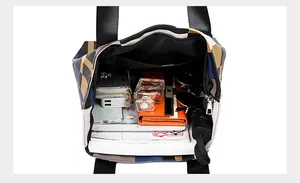 Macro detail of the spacious plaid tote bag interior with multiple storage compartments