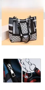 Macro shot of silver zipper closure and sturdy metal hardware on plaid tote bag