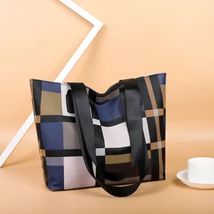 Minimalist large tote bag with geometric plaid pattern and wide black shoulder straps