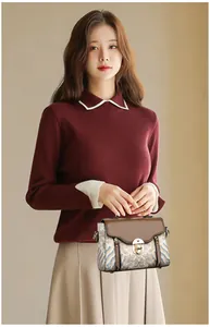Detail of elegant retro handbag with wave pattern and contrasting brown leather flap