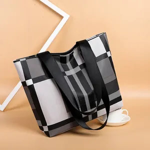 Minimalist black and white plaid canvas tote bag with nylon straps for daily commuting