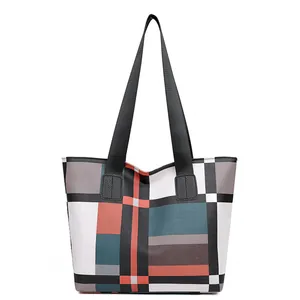 Minimalist large tote bag featuring modern geometric color block patterns for commuting