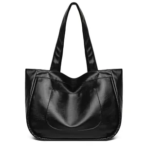 Polished black PU leather tote bag with large capacity and stylish front pocket detail