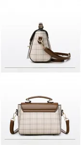 Detail view of retro plaid crossbody bag with brown leather accents and gold hardware