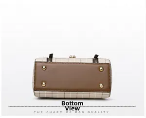 Close-up of plaid handbag bottom with brown leather base and four protective gold feet