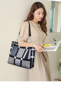 Detail of quilted geometric tote bag with silver chain strap and leather accents